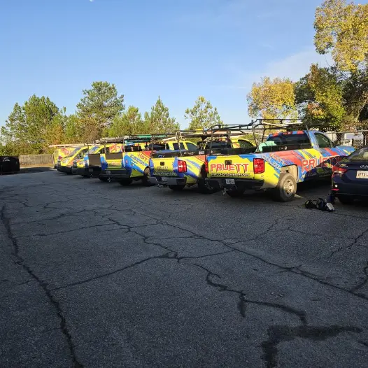 Fleet of Pruett Air Conditioning service trucks parked together