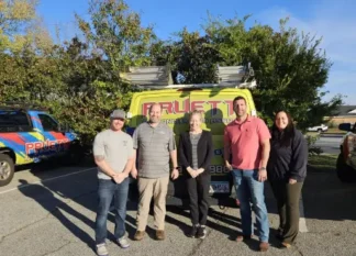 The team at Pruett Air Conditioning smiling together in front of a service van