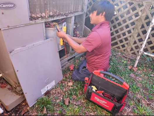 hvac-technician-multimeter-testing-carrier-ac-unit